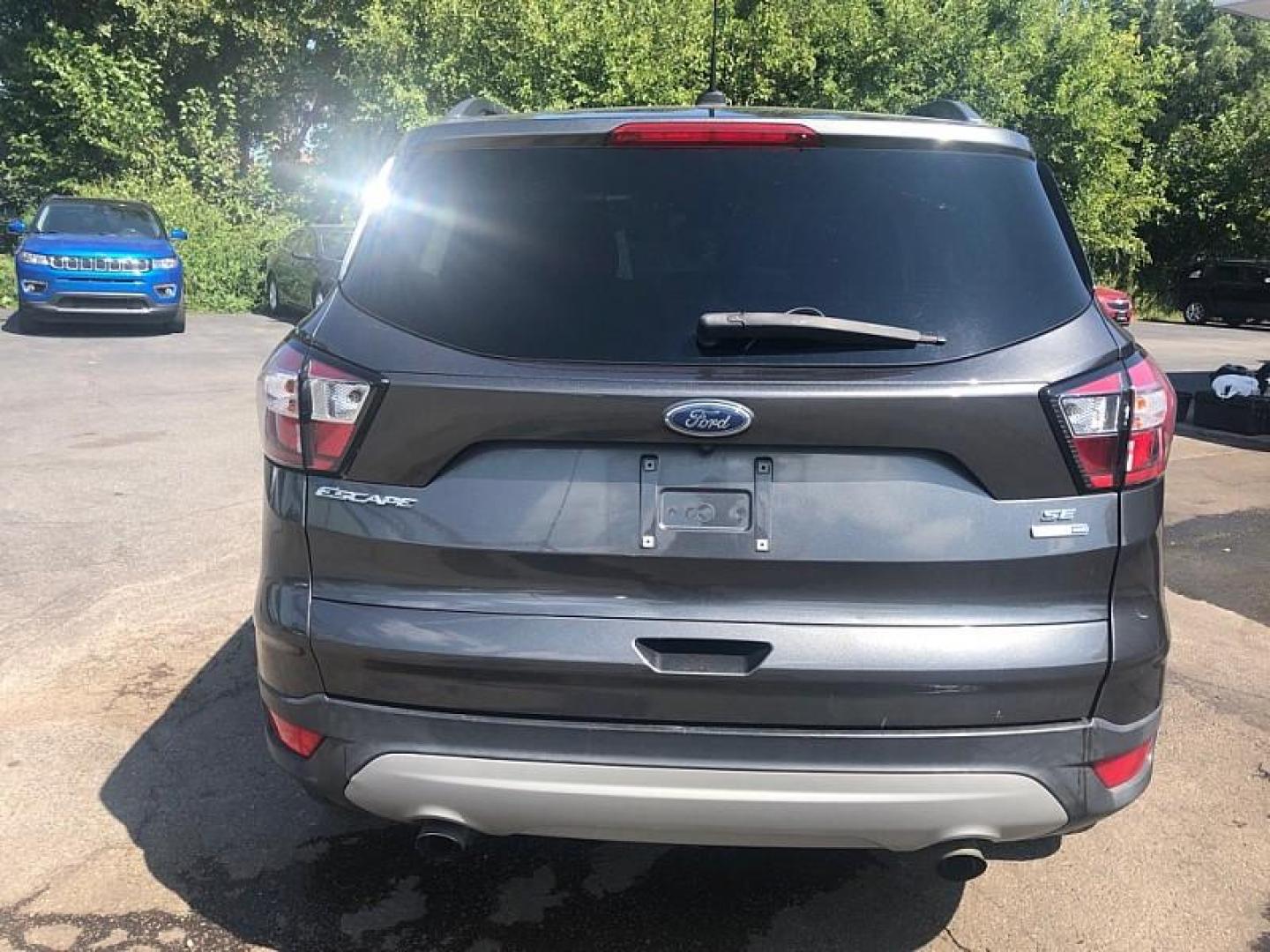 2018 GRAY /GREY Ford Escape SE 4WD (1FMCU9GD9JU) with an 1.5L L4 DOHC 16V engine, 6A transmission, located at 3304 Woodville Road, Northwood, OH, 43619, (419) 210-8019, 41.612694, -83.480743 - We are #1 Auto Loan Dealer for Good Bad or No Credit we have hundreds of vehicles to choose from, stop on in or just fill out our online application to get approved for auto financing and see your credit score for free by visiting our website today. We have Low Payment Options and Terms Available - Photo#3