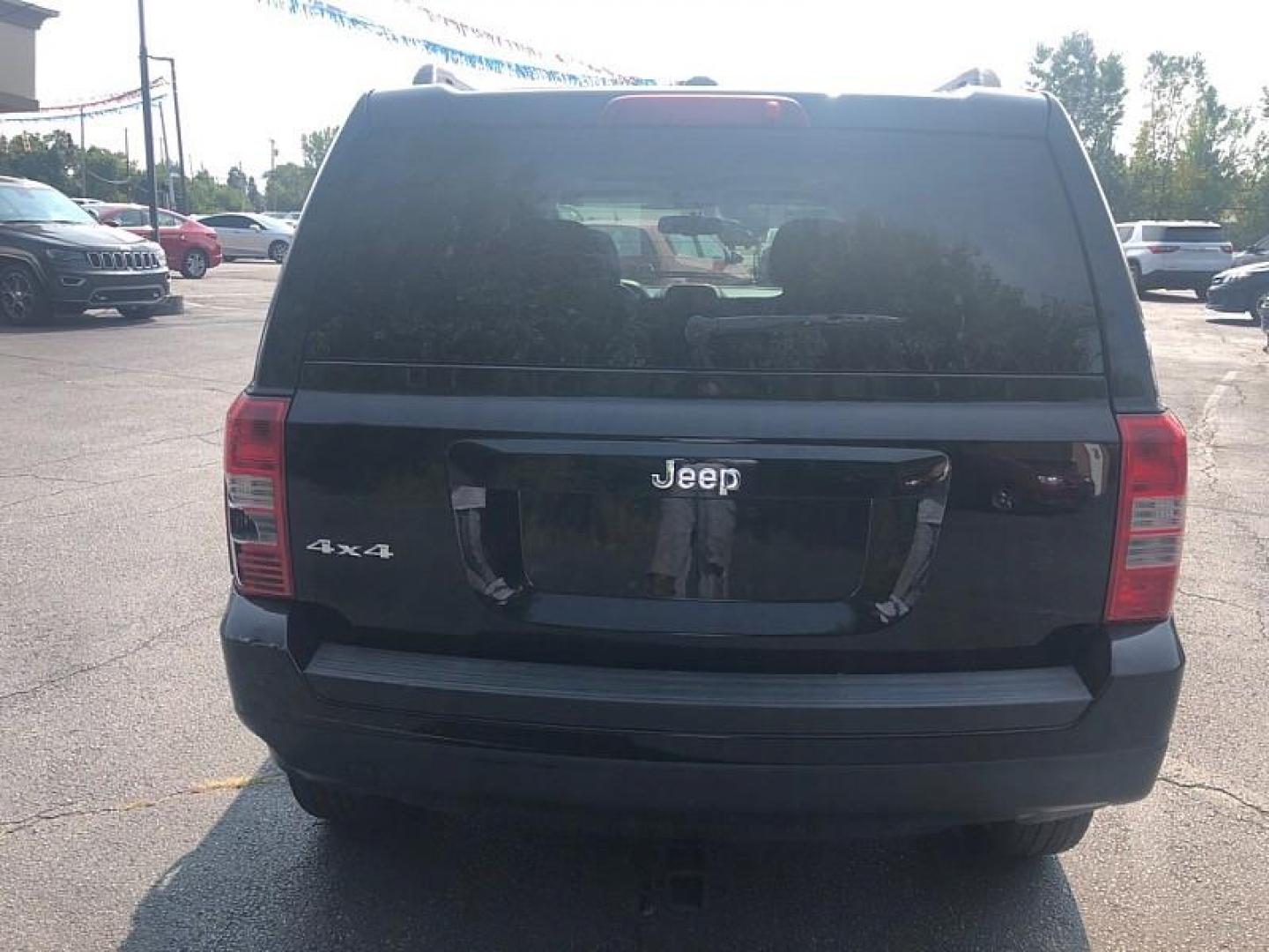 2014 BLACK /BLACK Jeep Patriot Latitude 4WD (1C4NJRFB0ED) with an 2.4L L4 DOHC 16V engine, Automatic 6-Spd w/AutoStick transmission, located at 3304 Woodville Road, Northwood, OH, 43619, (419) 210-8019, 41.612694, -83.480743 - We are #1 Auto Loan Dealer for Good Bad or No Credit we have hundreds of vehicles to choose from, stop on in or just fill out our online application to get approved for auto financing and see your credit score for free by visiting our website today. We have Low Payment Options and Terms Available - Photo#3