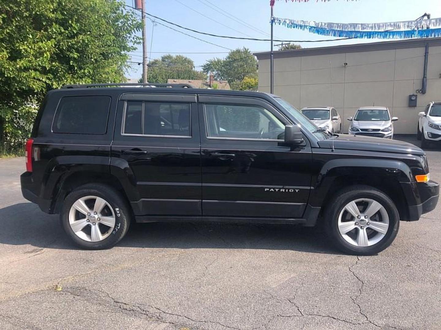 2014 BLACK /BLACK Jeep Patriot Latitude 4WD (1C4NJRFB0ED) with an 2.4L L4 DOHC 16V engine, Automatic 6-Spd w/AutoStick transmission, located at 3304 Woodville Road, Northwood, OH, 43619, (419) 210-8019, 41.612694, -83.480743 - We are #1 Auto Loan Dealer for Good Bad or No Credit we have hundreds of vehicles to choose from, stop on in or just fill out our online application to get approved for auto financing and see your credit score for free by visiting our website today. We have Low Payment Options and Terms Available - Photo#5