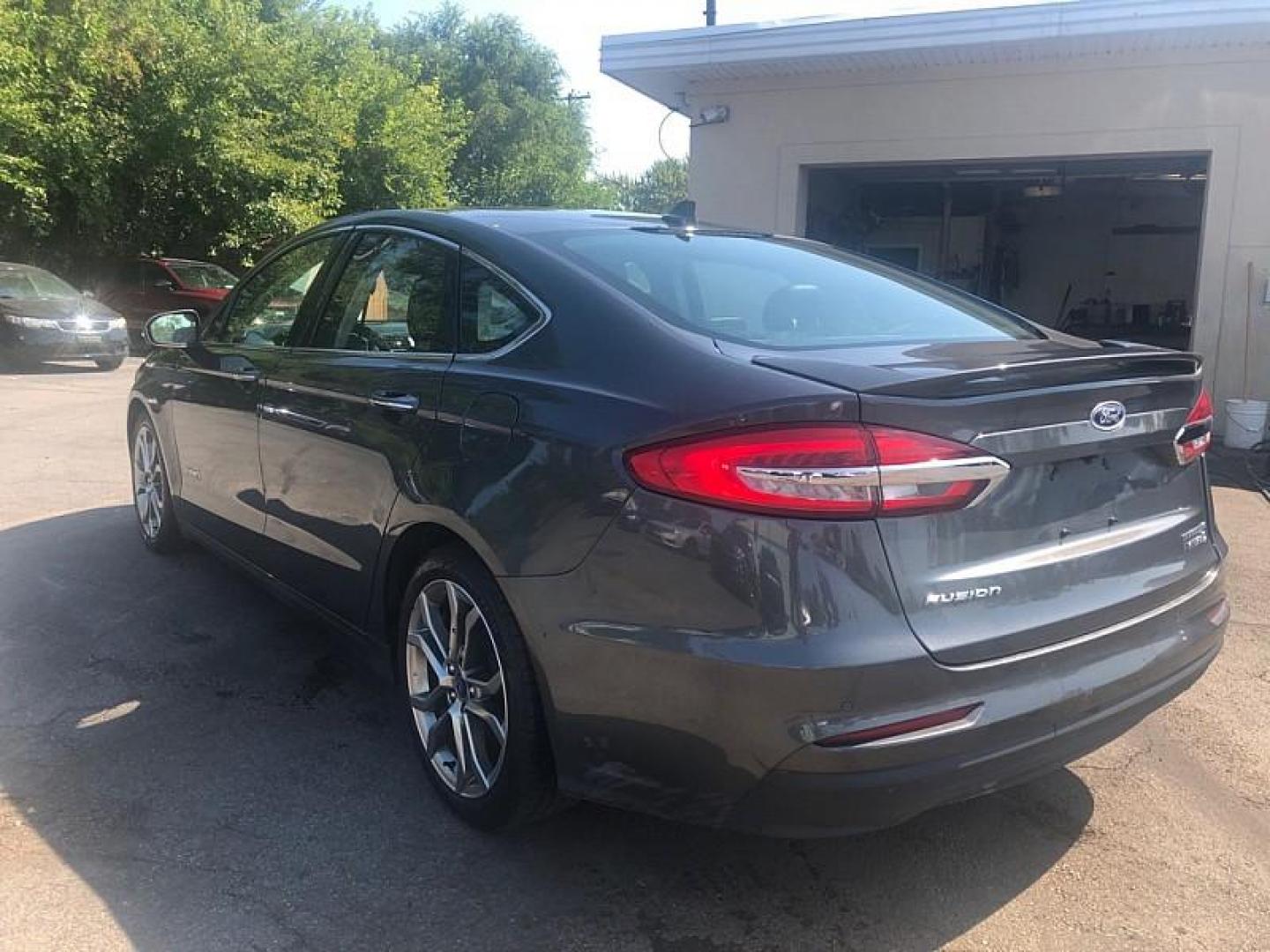 2019 GRAY /BLACK Ford Fusion Hybrid Titanium (3FA6P0RU2KR) with an 2.0L L4 DOHC 16V HYBRID engine, CVT transmission, located at 3304 Woodville Road, Northwood, OH, 43619, (419) 210-8019, 41.612694, -83.480743 - We are #1 Auto Loan Dealer for Good Bad or No Credit we have hundreds of vehicles to choose from, stop on in or just fill out our online application to get approved for auto financing and see your credit score for free by visiting our website today. We have Low Payment Options and Terms Available - Photo#2