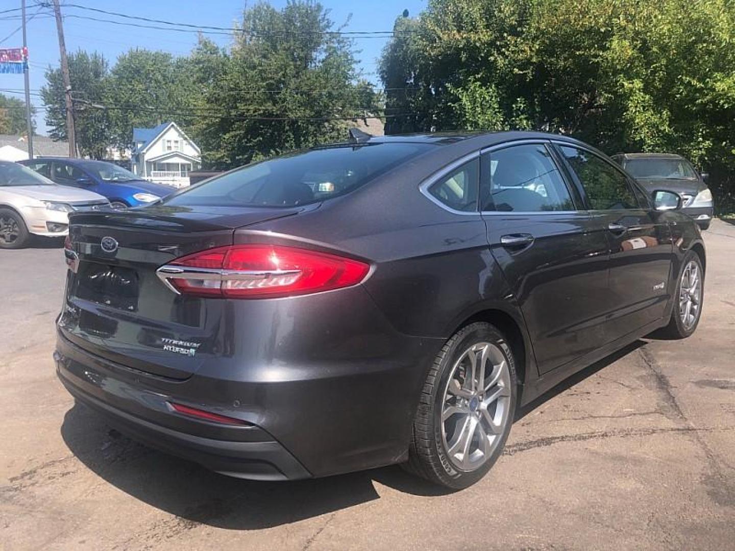 2019 GRAY /BLACK Ford Fusion Hybrid Titanium (3FA6P0RU2KR) with an 2.0L L4 DOHC 16V HYBRID engine, CVT transmission, located at 3304 Woodville Road, Northwood, OH, 43619, (419) 210-8019, 41.612694, -83.480743 - We are #1 Auto Loan Dealer for Good Bad or No Credit we have hundreds of vehicles to choose from, stop on in or just fill out our online application to get approved for auto financing and see your credit score for free by visiting our website today. We have Low Payment Options and Terms Available - Photo#4