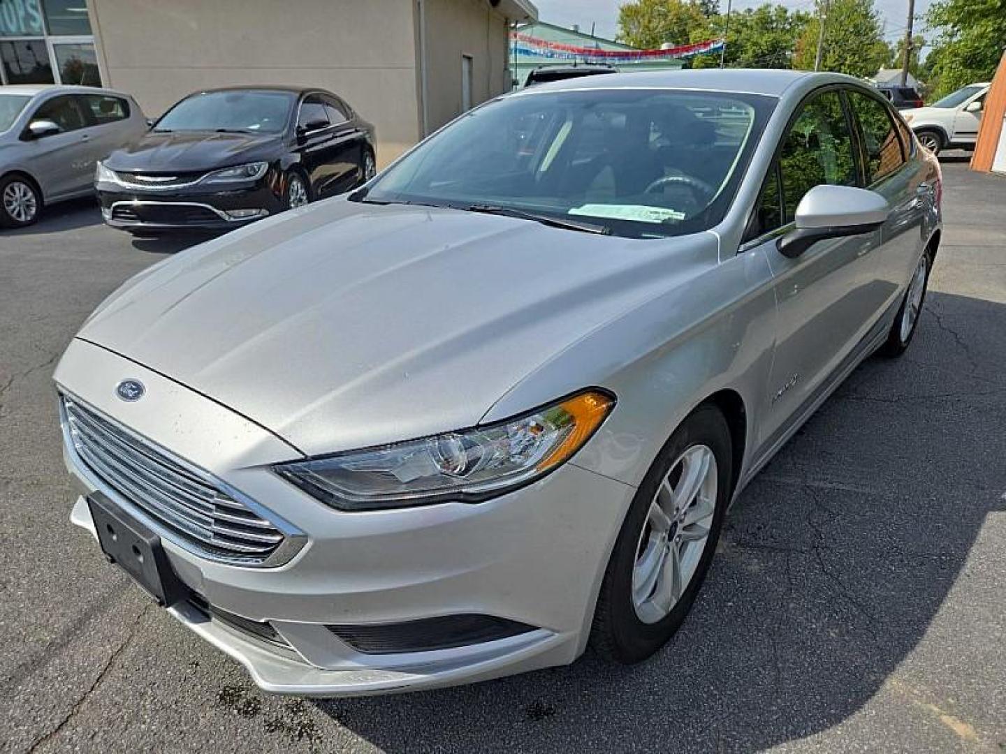 2018 SILVER /BLACK Ford Fusion Hybrid SE (3FA6P0LU9JR) with an 2.0L L4 DOHC 16V HYBRID engine, CVT transmission, located at 3304 Woodville Road, Northwood, OH, 43619, (419) 210-8019, 41.612694, -83.480743 - Your #1 Destination for Auto Loans and mdash;No Matter Your Credit!At our dealership, we cater to everyone and mdash;whether you have good, bad, or no credit. With hundreds of vehicles to choose from, you can easily find the perfect car, truck, or SUV that fits your needs.Get Approved Today!Visit ou - Photo#0