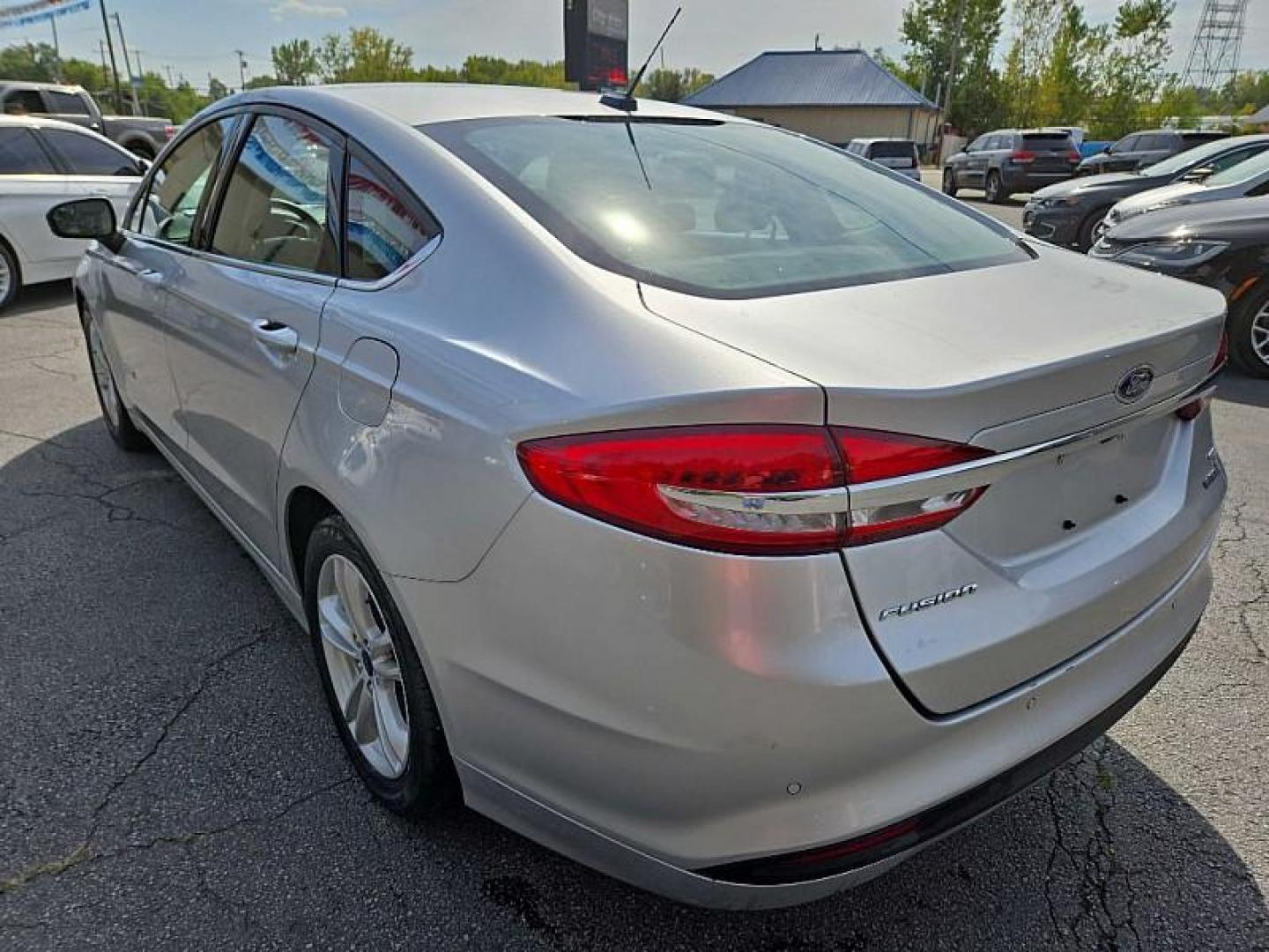 2018 SILVER /BLACK Ford Fusion Hybrid SE (3FA6P0LU9JR) with an 2.0L L4 DOHC 16V HYBRID engine, CVT transmission, located at 3304 Woodville Road, Northwood, OH, 43619, (419) 210-8019, 41.612694, -83.480743 - Your #1 Destination for Auto Loans and mdash;No Matter Your Credit!At our dealership, we cater to everyone and mdash;whether you have good, bad, or no credit. With hundreds of vehicles to choose from, you can easily find the perfect car, truck, or SUV that fits your needs.Get Approved Today!Visit ou - Photo#2