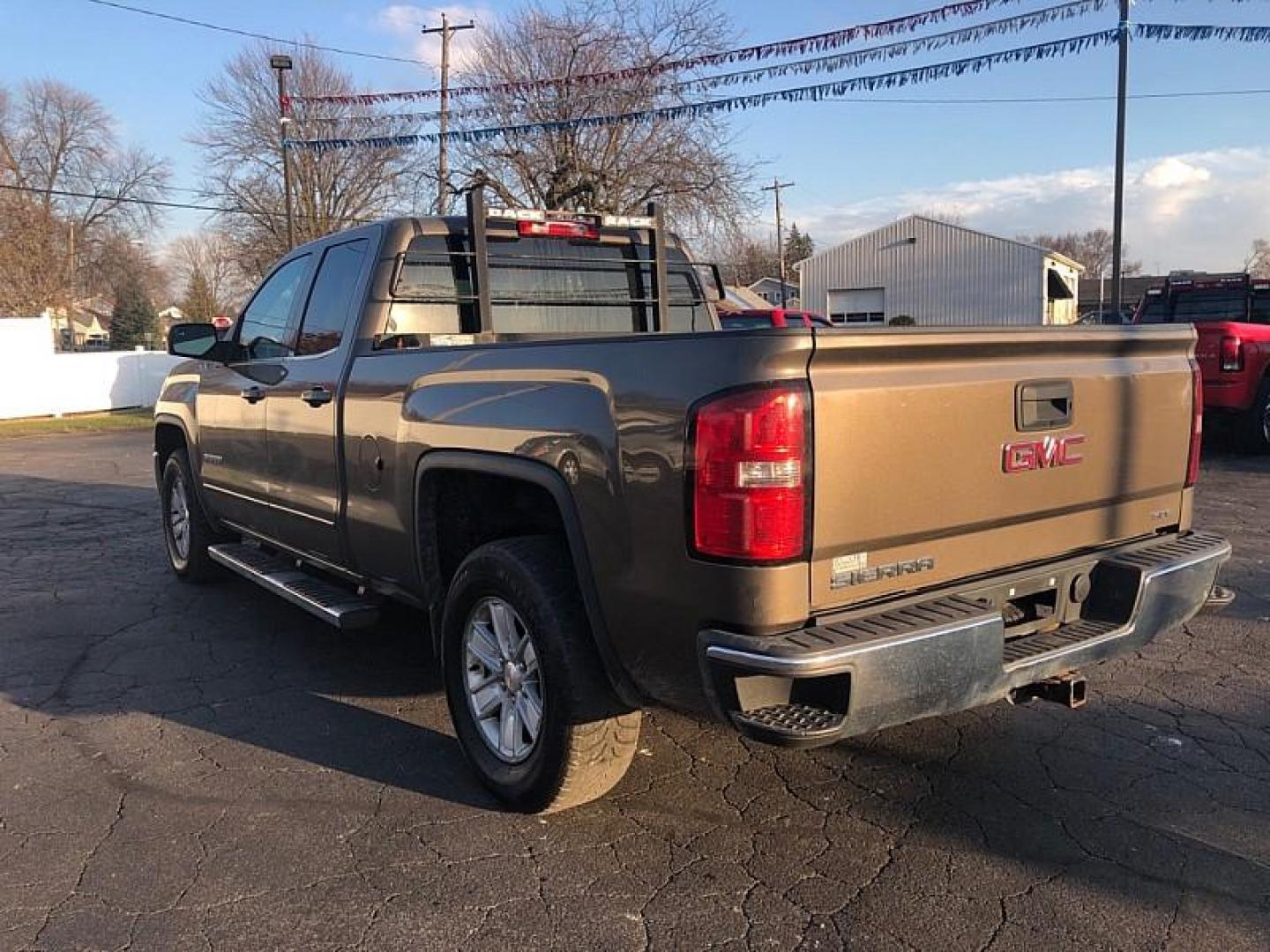 2013 TAN /BLACK GMC Sierra 1500 SLE Ext. Cab 4WD (1GTV2UEC9EZ) with an 5.3L V8 OHV 16V engine, 6-Speed Automatic transmission, located at 3304 Woodville Road, Northwood, OH, 43619, (419) 210-8019, 41.612694, -83.480743 - Your #1 Destination for Auto Loans and mdash;No Matter Your Credit!At our dealership, we believe everyone deserves the opportunity to drive their dream car and mdash;whether you have good credit, bad credit, or no credit at all. With a wide selection of hundreds of cars, trucks, and SUVs, you'll fin - Photo#2