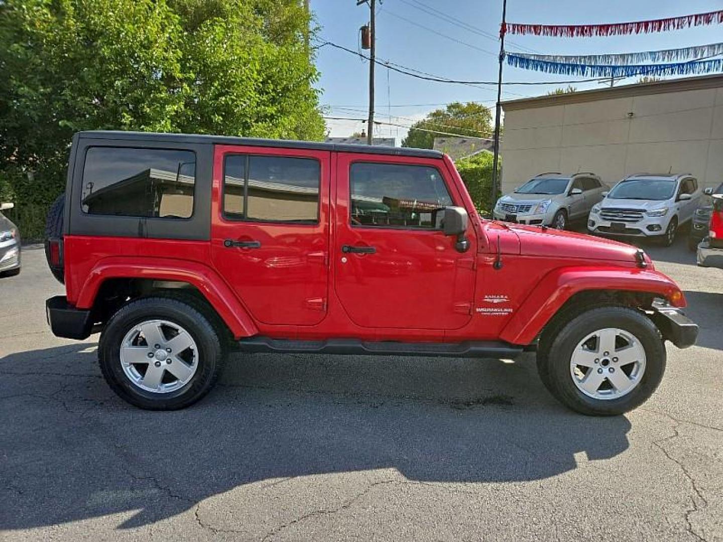 2011 RED /BLACK Jeep Wrangler Unlimited Sahara 4WD (1J4BA5H11BL) with an 3.8L V6 OHV 12V engine, Automatic 4-Spd w/Overdrive transmission, located at 3304 Woodville Road, Northwood, OH, 43619, (419) 210-8019, 41.612694, -83.480743 - We are #1 Auto Loan Dealer for Good Bad or No Credit we have hundreds of vehicles to choose from, stop on in or just fill out our online application to get approved for auto financing and see your credit score for free by visiting our website today. We have Low Payment Options and Terms Available - Photo#4